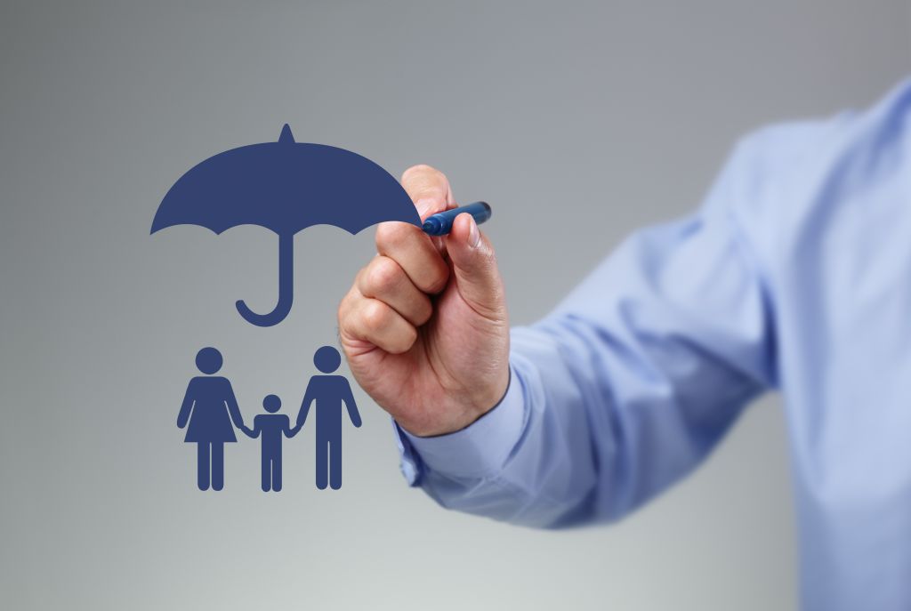 Family protection Businessman hand drawing an umbrella above a family concept for protection, security, finance and insurance